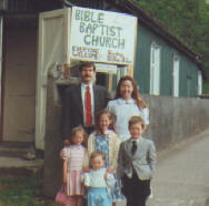 The Ledbetter family in front of the church sign